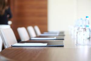 A desk in a boardroom setting