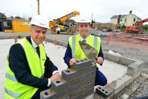 Minister lays one of the the first bricks at a £13million Choice Housing scheme which will provide 106 new two and three bedroom family homes