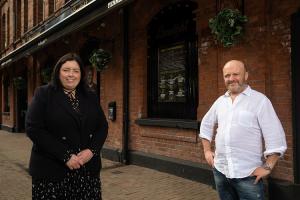 Communities Minister Deirdre Hargey is pictured with Alan Simms during a visit to The Limelight in Belfast, a live music venue.