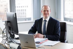 Minister Lyons sitting at his desk